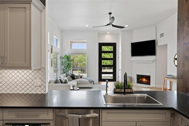 611 Ladin Ln, Lakeway, TX 78734 - kitchen with open floor plan, dishwasher, a brick fireplace, a ceiling fan, and dark countertops