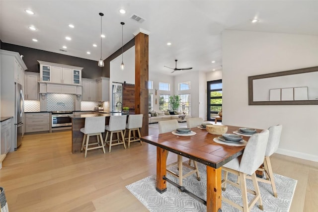 611 Ladin Ln, Lakeway, TX 78734 - dining space featuring a barn door, light wood-type flooring, recessed lighting, and ceiling fan