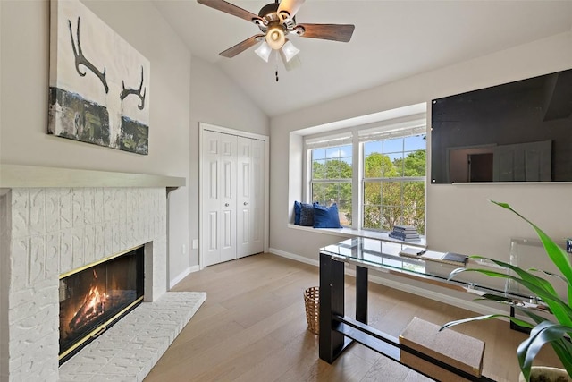 611 Ladin Ln, Lakeway, TX 78734 - office area featuring wood finished floors, vaulted ceiling, a ceiling fan, and a glass covered fireplace