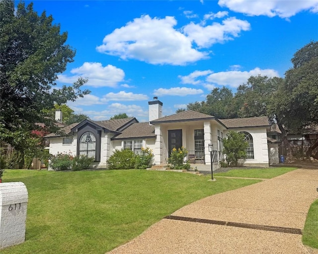 611 Ladin Ln, Lakeway, TX 78734 - view of front of house with a front lawn and a chimney