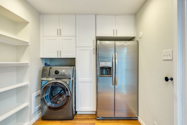 7409 Shadow Hill Dr Unit 105, Austin, TX 78731 - washroom featuring washer / dryer, cabinet space, and light wood-type flooring
