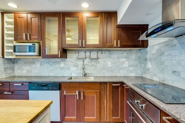 7409 Shadow Hill Dr Unit 105, Austin, TX 78731 - kitchen featuring stainless steel appliances, a sink, wall chimney exhaust hood, glass insert cabinets, and decorative backsplash