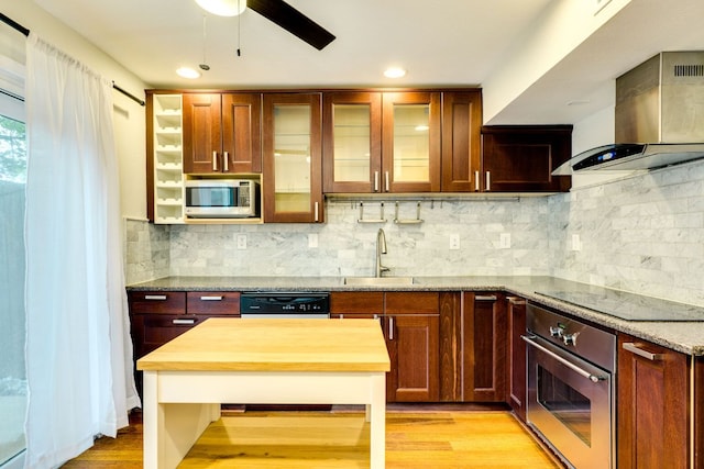 7409 Shadow Hill Dr Unit 105, Austin, TX 78731 - kitchen featuring black appliances, wall chimney range hood, a sink, ceiling fan, and light wood-style flooring