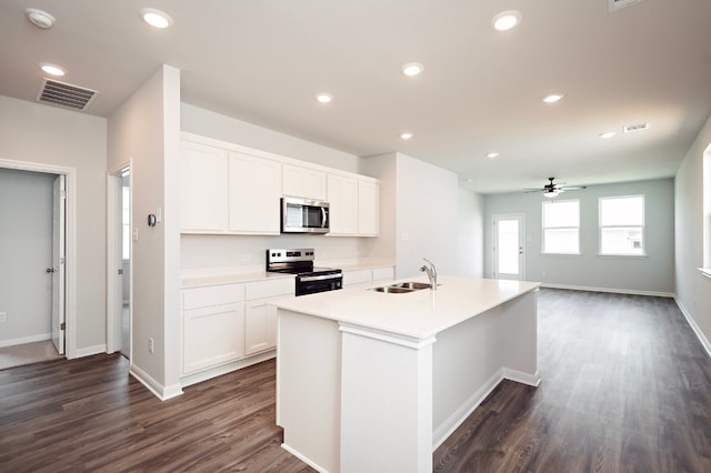 205 Escape Way, Jarrell, TX 76537 - kitchen with stainless steel appliances, a sink, dark wood-style flooring, a center island with sink, and recessed lighting