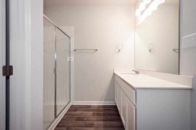 205 Escape Way, Jarrell, TX 76537 - full bathroom featuring wood finished floors, vanity, a shower stall, and baseboards