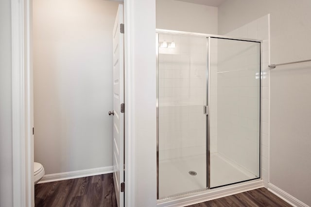 205 Escape Way, Jarrell, TX 76537 - full bath featuring a stall shower, wood finished floors, toilet, and baseboards