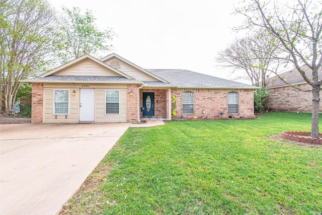 ranch-style home with brick siding, roof with shingles, a front lawn, and concrete driveway