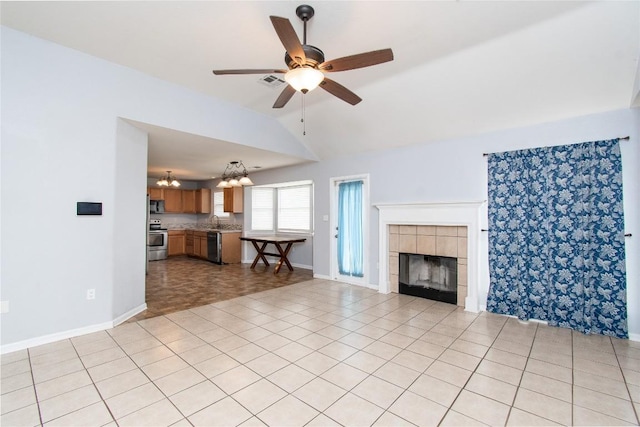 7201 Pappus Ct, Temple, TX 76502 - unfurnished living room with lofted ceiling, a ceiling fan, a tile fireplace, and a chandelier