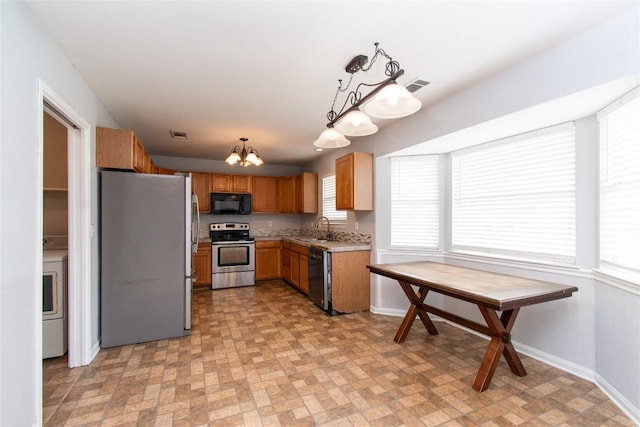 7201 Pappus Ct, Temple, TX 76502 - kitchen featuring stainless steel appliances, washer / dryer, a chandelier, brick patterned floors, and light countertops