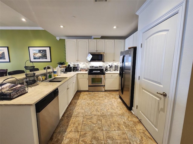 1001 The Cape Rd Unit 32, Horseshoe Bay, TX 78657 - kitchen featuring appliances with stainless steel finishes, a peninsula, light countertops, decorative backsplash, and ornamental molding