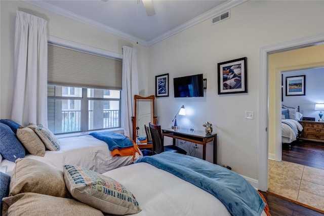 1001 The Cape Rd Unit 32, Horseshoe Bay, TX 78657 - bedroom featuring crown molding, wood finished floors, and ceiling fan