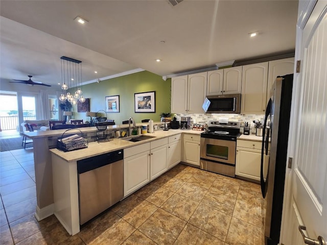 1001 The Cape Rd Unit 32, Horseshoe Bay, TX 78657 - kitchen with stainless steel appliances, a peninsula, decorative backsplash, open floor plan, and light countertops