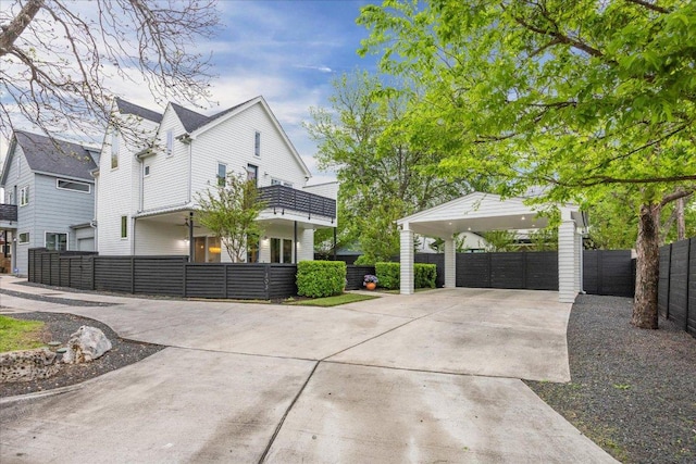 1303 Harriet Ct Unit A, Austin, TX 78756 - view of property exterior with driveway, a detached carport, and a balcony