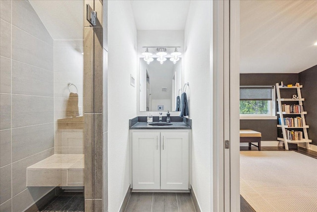 1303 Harriet Ct Unit A, Austin, TX 78756 - full bathroom featuring wood finished floors, vanity, and a tile shower