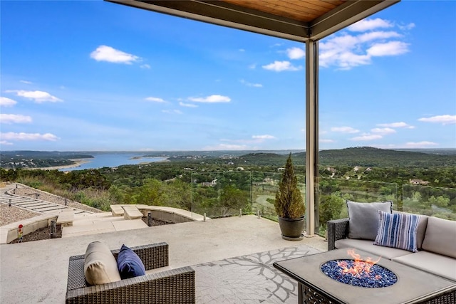 8612 Tip Top Dr Unit 2, Jonestown, TX 78645 - view of patio featuring an outdoor living space with a fire pit, a wooded view, and a water view