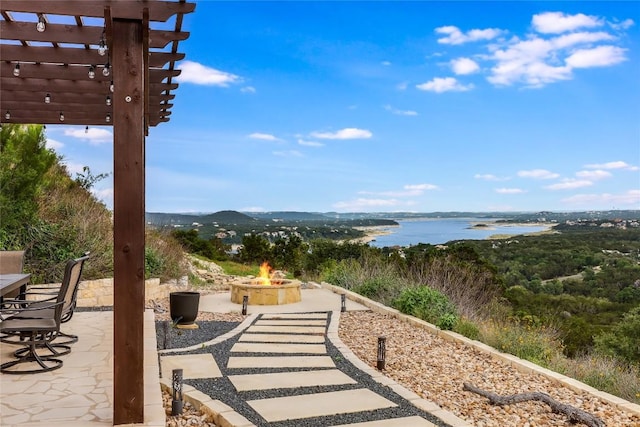 8612 Tip Top Dr Unit 2, Jonestown, TX 78645 - view of patio with an outdoor fire pit, a pergola, and a water view