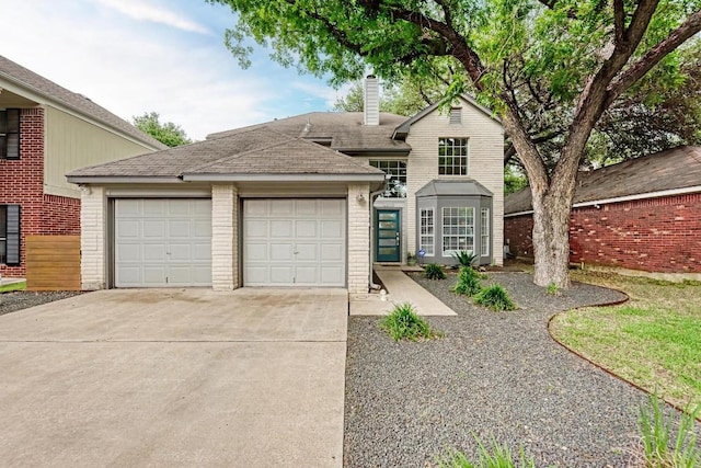 12203 Arrowwood Dr, Austin, TX 78727 - traditional-style home featuring brick siding, a garage, concrete driveway, a chimney, and a shingled roof