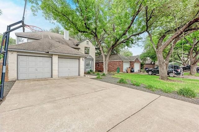 12203 Arrowwood Dr, Austin, TX 78727 - traditional home with brick siding, roof with shingles, a chimney, driveway, and a front lawn
