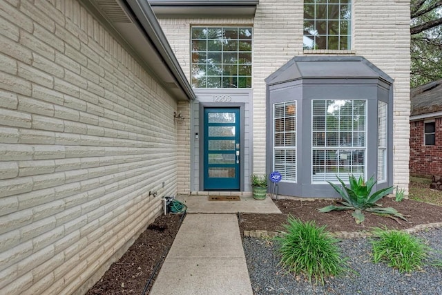 12203 Arrowwood Dr, Austin, TX 78727 - doorway to property featuring brick siding