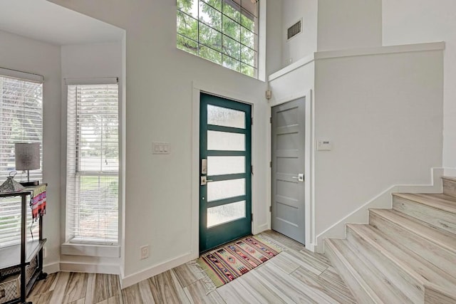 12203 Arrowwood Dr, Austin, TX 78727 - foyer with stairs, healthy amount of natural light, and wood finished floors