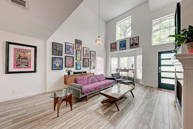 12203 Arrowwood Dr, Austin, TX 78727 - living room featuring high vaulted ceiling, wood tiled floors, and a fireplace