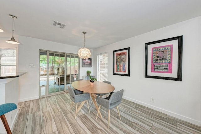 12203 Arrowwood Dr, Austin, TX 78727 - dining area with a chandelier and wood tiled floors