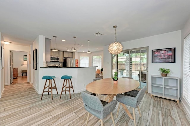 12203 Arrowwood Dr, Austin, TX 78727 - dining room with light wood-style floors, a chandelier, and recessed lighting
