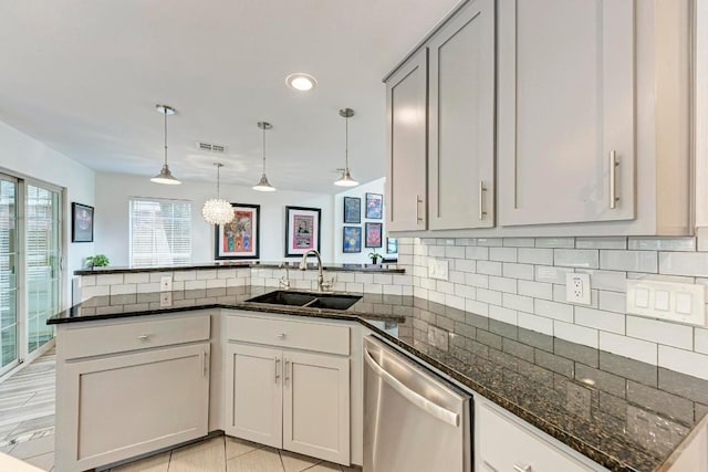 12203 Arrowwood Dr, Austin, TX 78727 - kitchen featuring stainless steel dishwasher, a peninsula, backsplash, dark stone counters, and recessed lighting