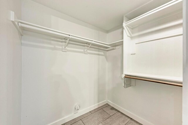 12203 Arrowwood Dr, Austin, TX 78727 - spacious closet featuring light tile patterned floors