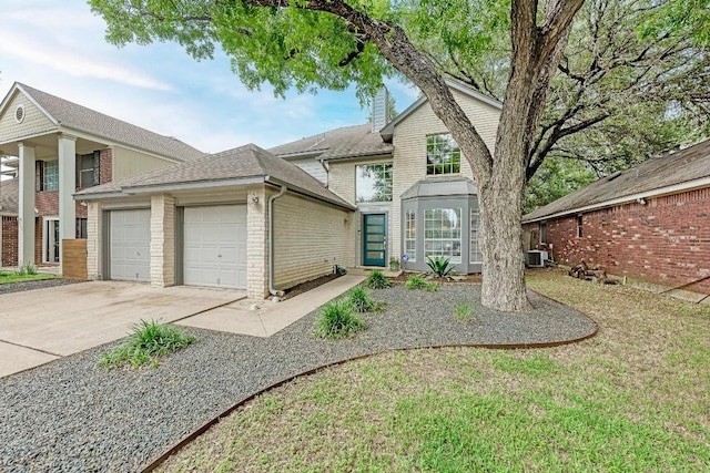 12203 Arrowwood Dr, Austin, TX 78727 - traditional-style house featuring a garage, brick siding, driveway, central AC, and a shingled roof
