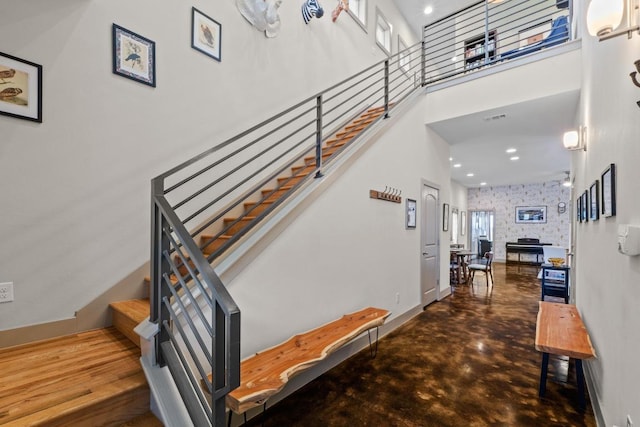 1907 E 20th St, Austin, TX 78722 - staircase featuring a high ceiling, finished concrete flooring, and recessed lighting