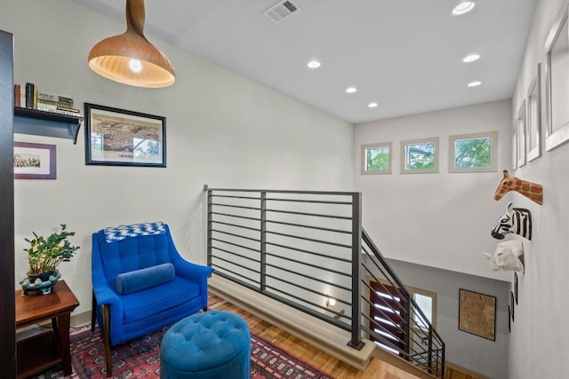 1907 E 20th St, Austin, TX 78722 - sitting room with wood finished floors, recessed lighting, and an upstairs landing
