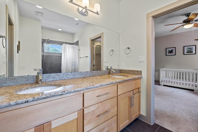 1907 E 20th St, Austin, TX 78722 - full bath featuring double vanity, ceiling fan, a shower with shower curtain, and tile patterned floors