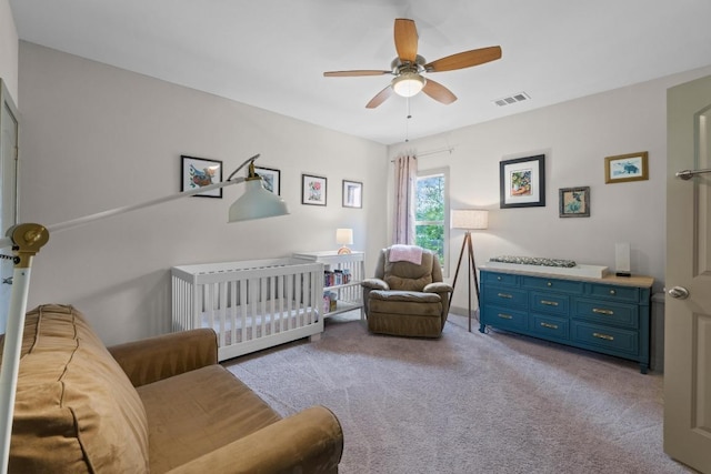 1907 E 20th St, Austin, TX 78722 - bedroom featuring light colored carpet, ceiling fan, and a crib