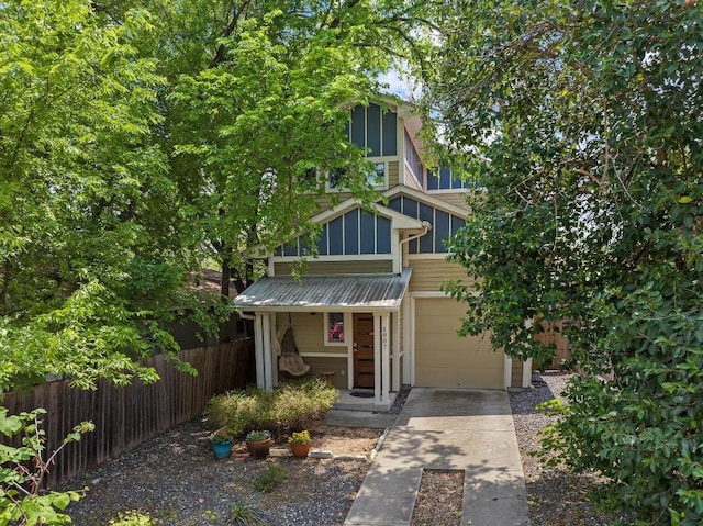 1907 E 20th St, Austin, TX 78722 - view of front of property featuring driveway, an attached garage, and a metal roof