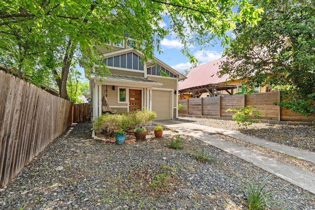 1907 E 20th St, Austin, TX 78722 - mid-century modern home featuring driveway, an attached garage, a metal roof, and a fenced backyard