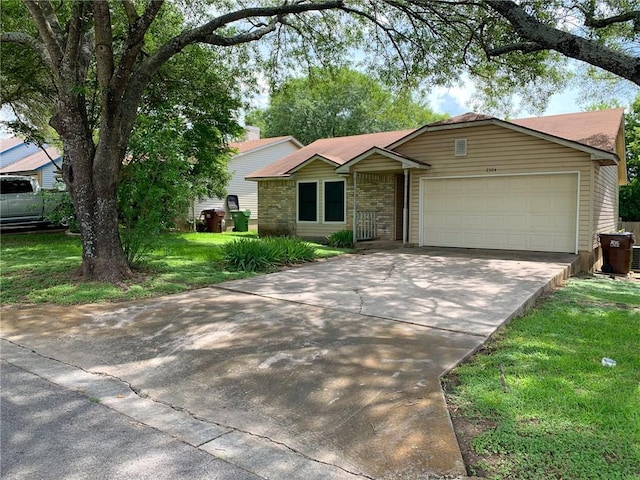 2304 Lasso Dr, Round Rock, TX 78681 - ranch-style home featuring concrete driveway, an attached garage, a front yard, and brick siding