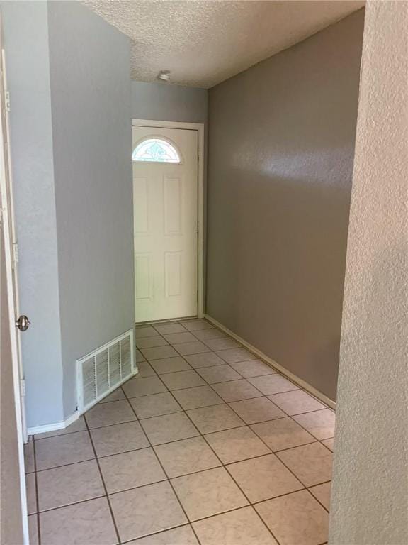 2304 Lasso Dr, Round Rock, TX 78681 - entryway with a textured ceiling and light tile patterned flooring
