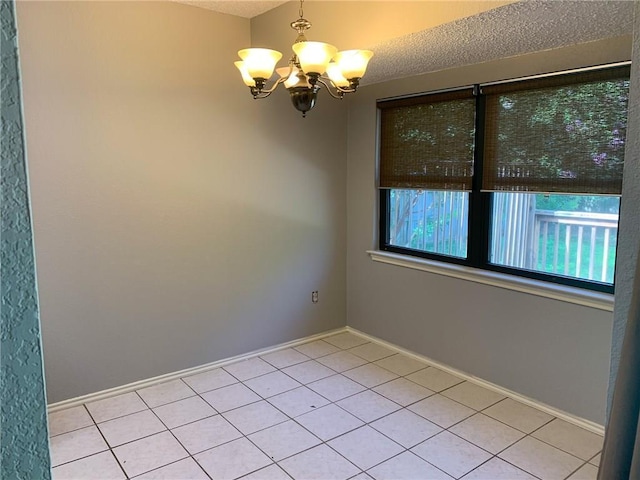 2304 Lasso Dr, Round Rock, TX 78681 - unfurnished room with a chandelier, light tile patterned flooring, and a textured ceiling