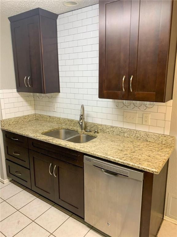 2304 Lasso Dr, Round Rock, TX 78681 - kitchen with stainless steel dishwasher, tasteful backsplash, light tile patterned flooring, light stone countertops, and dark brown cabinetry