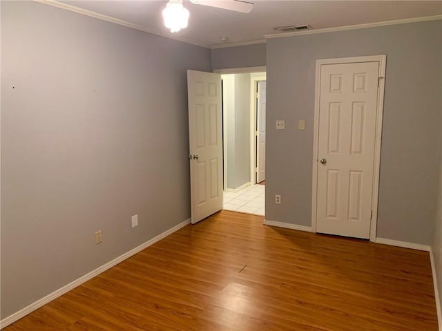 2304 Lasso Dr, Round Rock, TX 78681 - unfurnished bedroom with ornamental molding, wood finished floors, and ceiling fan
