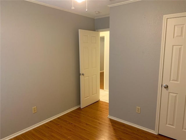 2304 Lasso Dr, Round Rock, TX 78681 - unfurnished bedroom with ornamental molding and wood finished floors