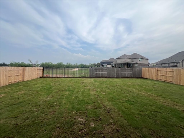 view of yard with a fenced backyard