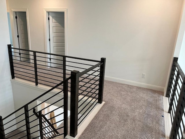 interior space with carpet floors and baseboards