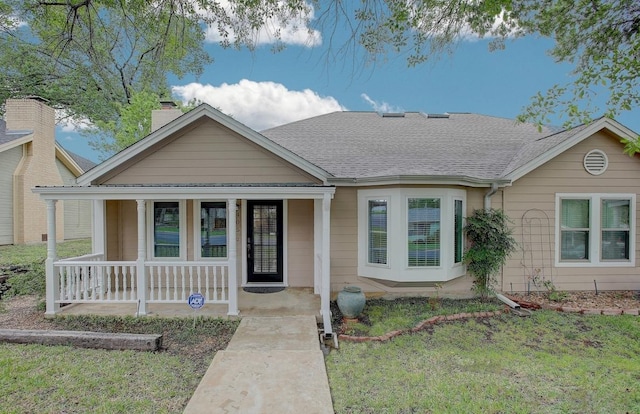 405 E 6th St, Georgetown, TX 78626 - view of front of home with roof with shingles, a chimney, a porch, and a front yard