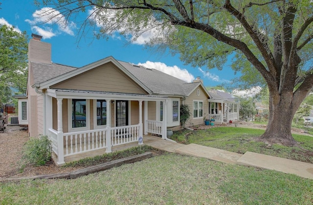 405 E 6th St, Georgetown, TX 78626 - bungalow-style home featuring a porch, a chimney, and a front yard