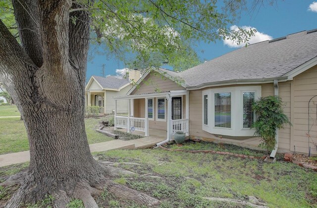 405 E 6th St, Georgetown, TX 78626 - view of front of house featuring a porch, a front yard, and roof with shingles
