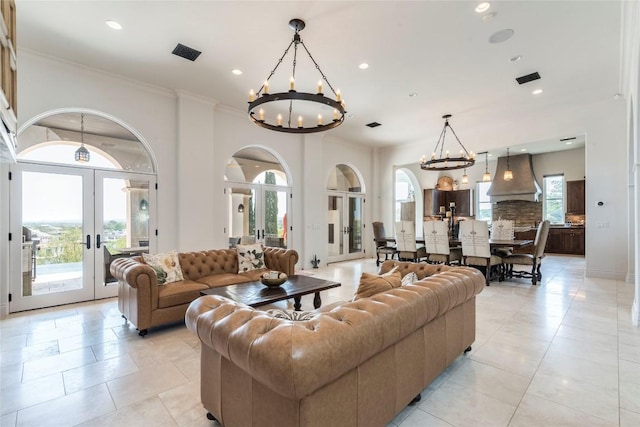 1300 Apache Tears, Horseshoe Bay, TX 78657 - living room with french doors, a chandelier, plenty of natural light, light tile patterned floors, and recessed lighting