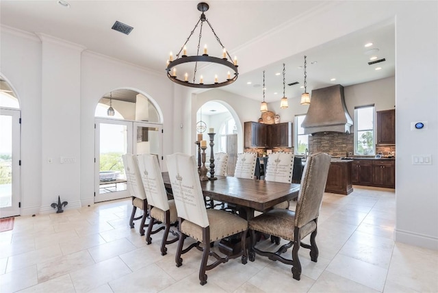 1300 Apache Tears, Horseshoe Bay, TX 78657 - dining area featuring arched walkways, a chandelier, plenty of natural light, ornamental molding, and light tile patterned floors