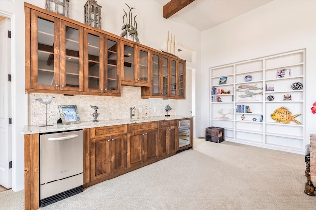 1300 Apache Tears, Horseshoe Bay, TX 78657 - kitchen with stainless steel dishwasher, light carpet, tasteful backsplash, glass insert cabinets, and beamed ceiling